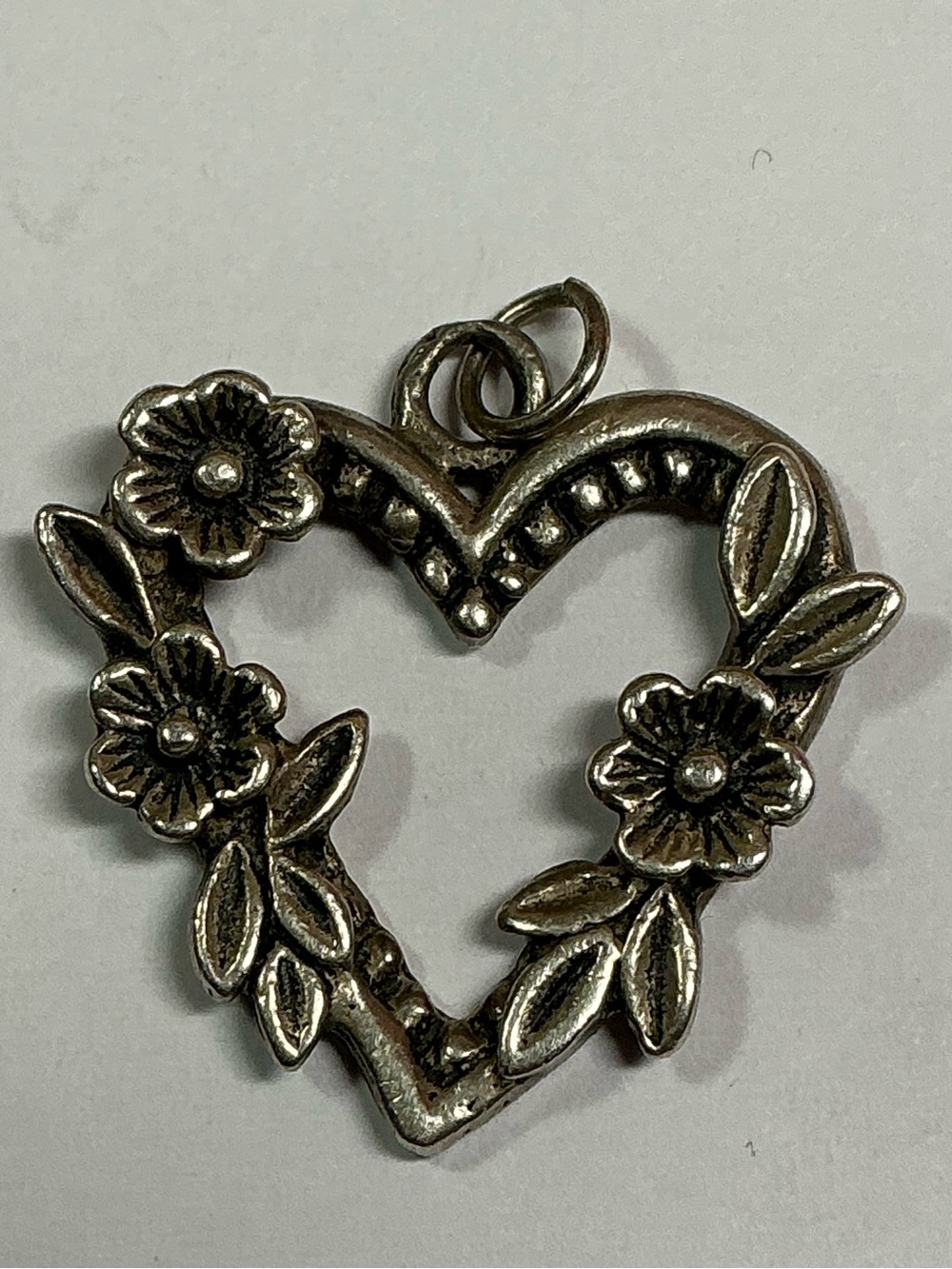 Sterling Silver Open Heart Shaped Pendant with floral accents.